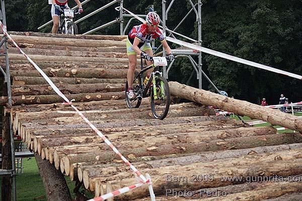 Gunn-Rita Dahle Flesj&aring; rides a log bridge.