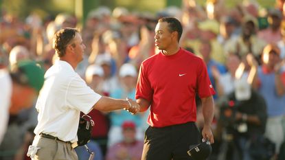 Chris DiMarco, left, and Tiger Woods shake hands after DiMarco made a putt at No. 18 to tie the match and send the tournament into a playoff 2005 Masters Tournament