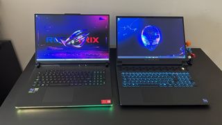 Alienware M18 and Asus ROG Strix Scar 18 gaming laptops side by side on a black desk