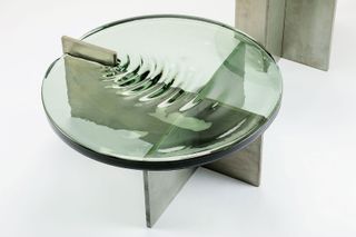 Detail of table whose green glass top looks like water surface