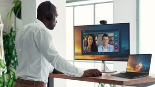 Dell Pro laptop being used for videoconferencing with an external monitor on a standing desk