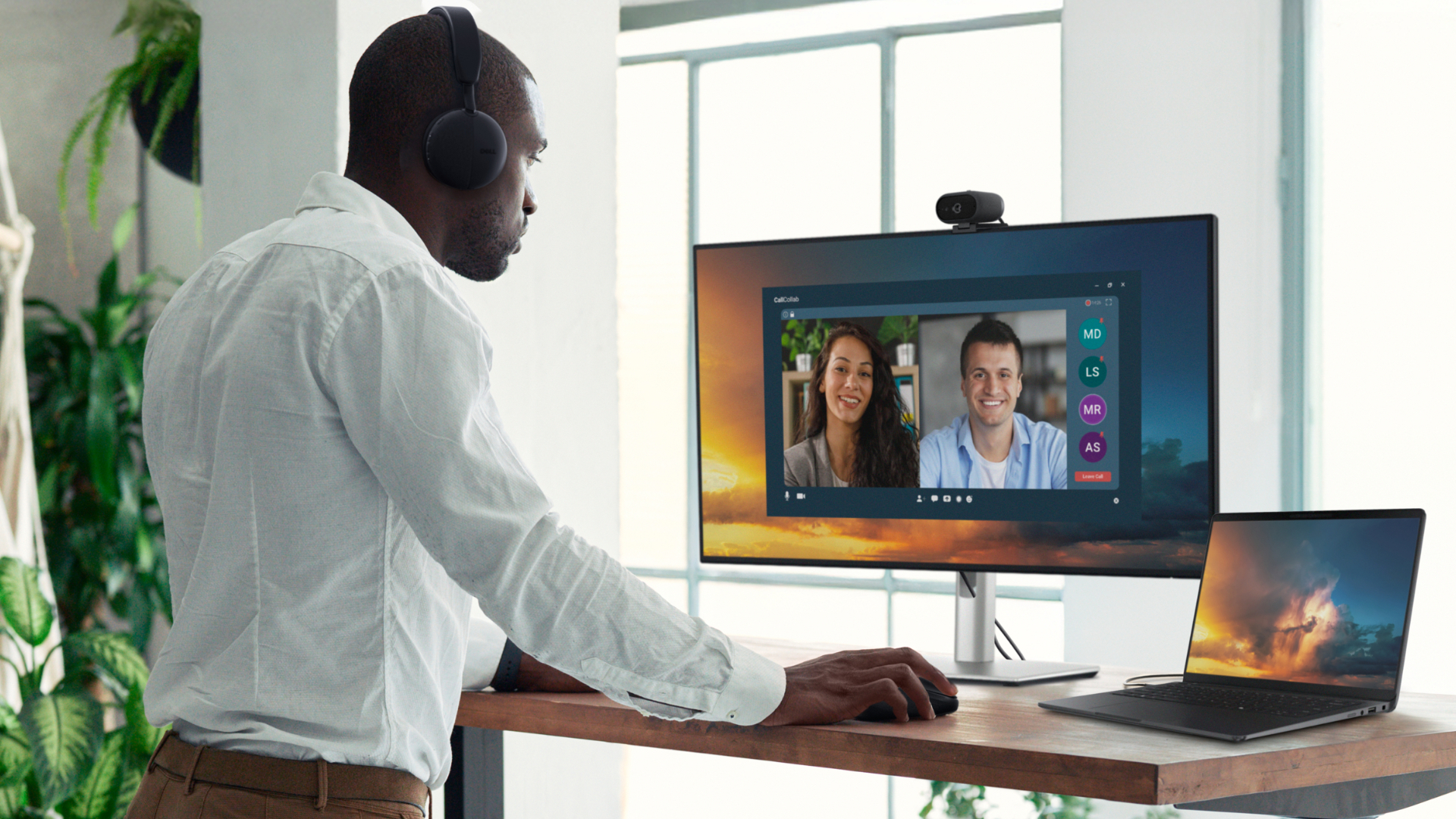 Dell Pro laptop being used for videoconferencing with an external monitor on a standing desk