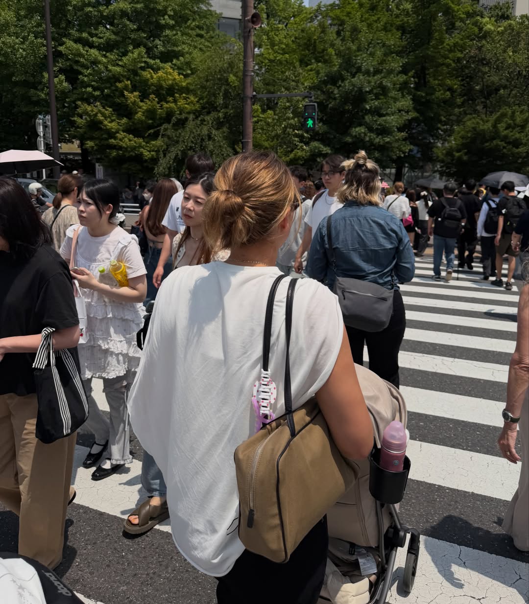 Sofia Richie Grainge shares photos wearing an Adidas track jacket, black baggy pants, and Prada snakeskin ballet sneakers, along with white shorts during a trip to Japan