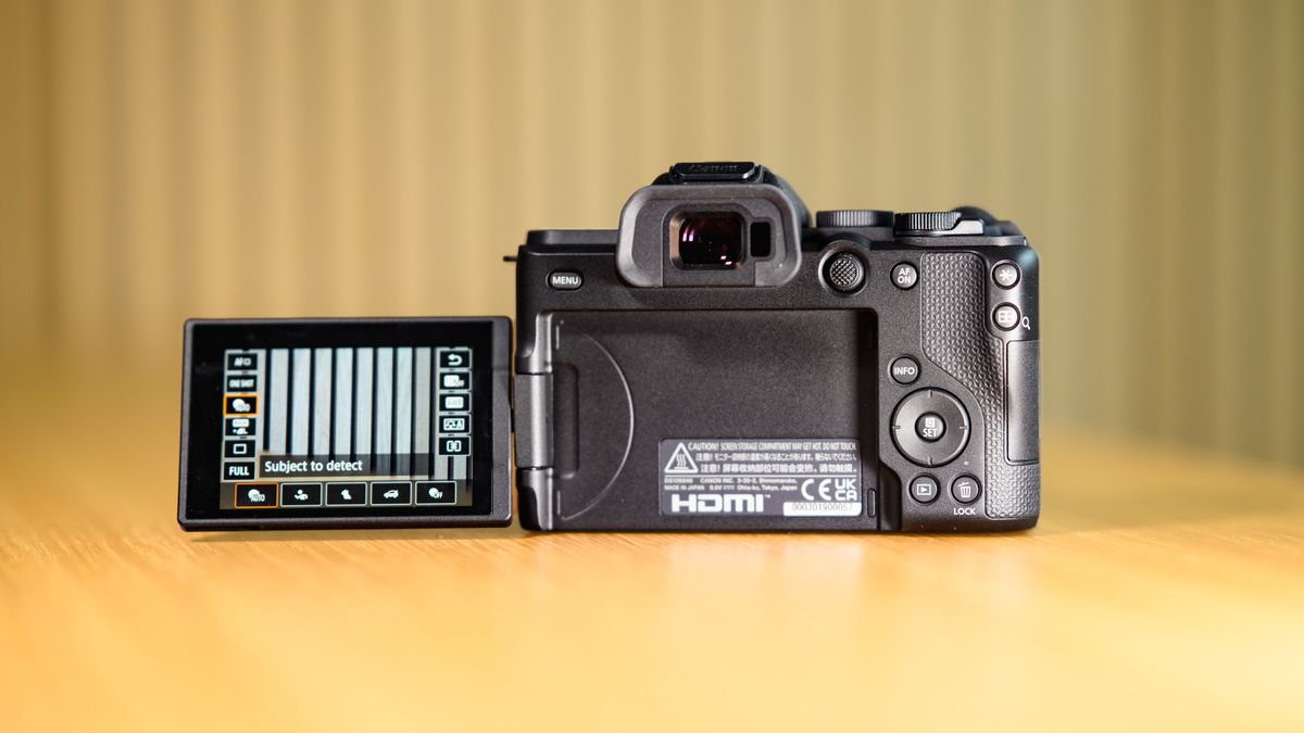 Rear of the Canon EOS R8 Mark II on a wooden table, screen flipped out