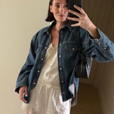 Influencer Sara Louise Blythe wears a white lace-trim set with an oversized jean jacket. 