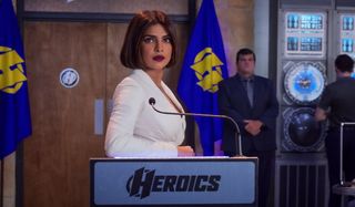 Priyanka Chopra Jones stands well dressed at a podium in We Can Be Heroes.