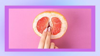 person touching a grapefruit with their fingers to illustrate how to finger yourself or someone else, against a pink background with a blue border