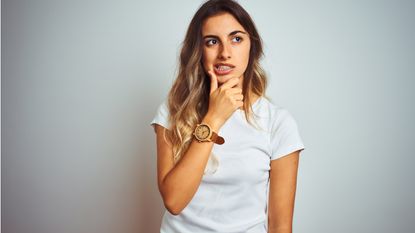 A young woman looks thoughtful.