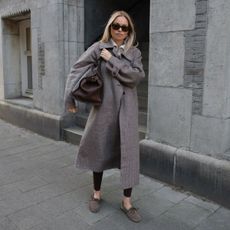 claire rose cliteur wears a coat, leggings and boat shoes