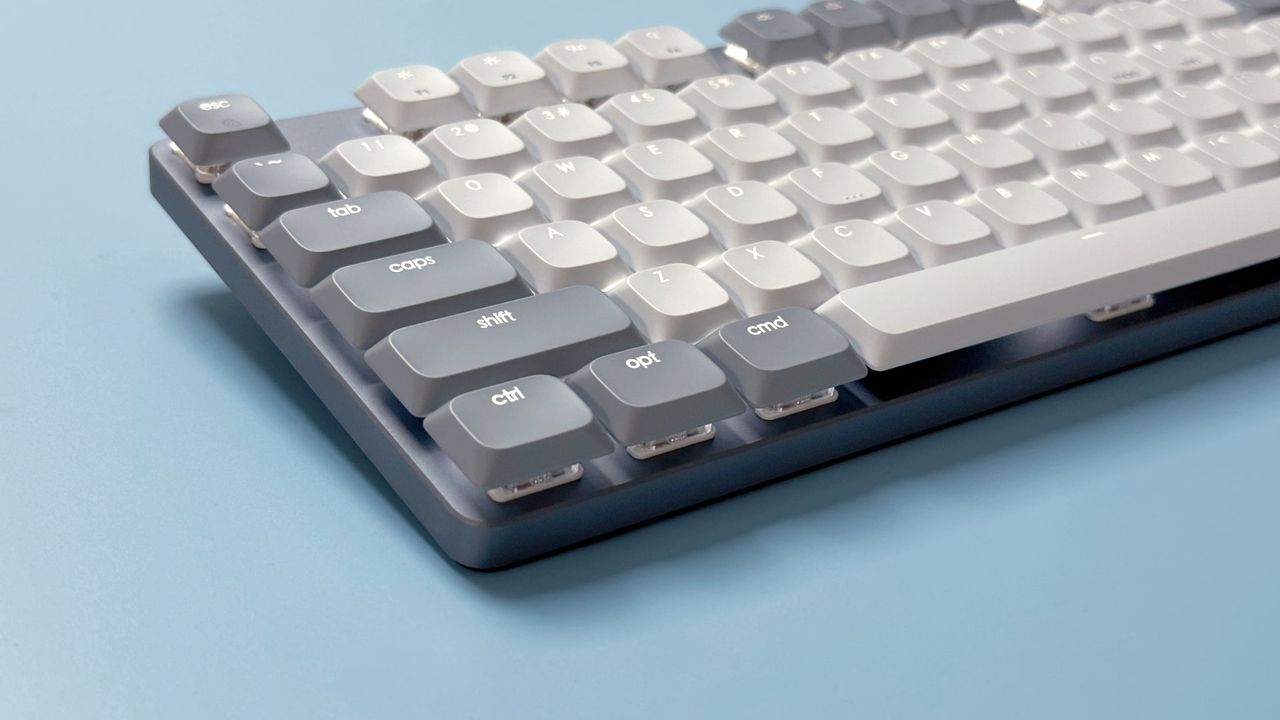 The Satechi SM3 mechanical keyboard against a blue background.