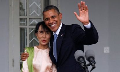 President Obama waves to the media as he embraces Myanmar opposition leader Aung San Suu Kyi at her residence in Yangon on Nov. 19. 