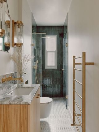 A bathroom with dark blue tiling