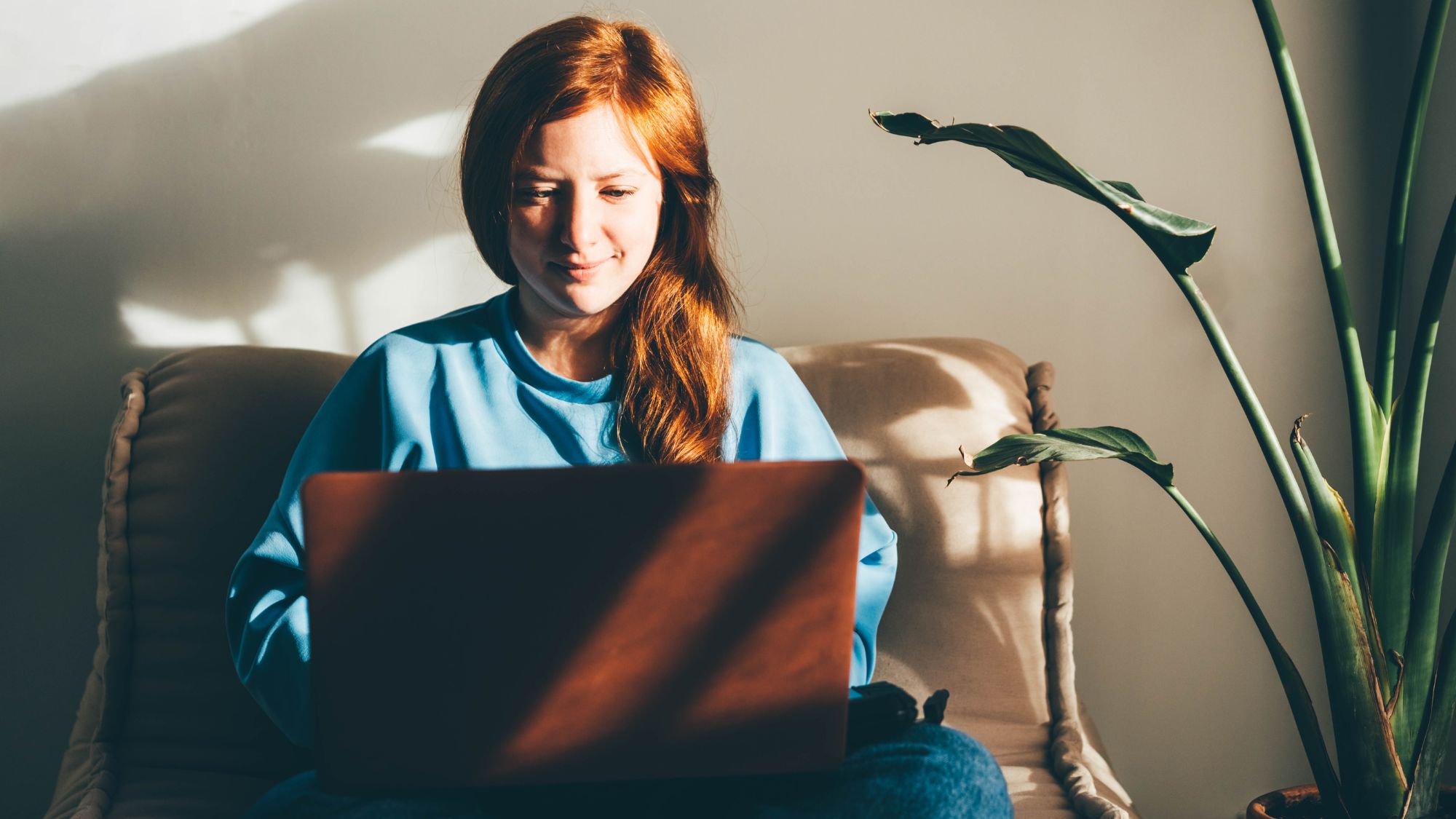 Young woman with laptop sorting her finances