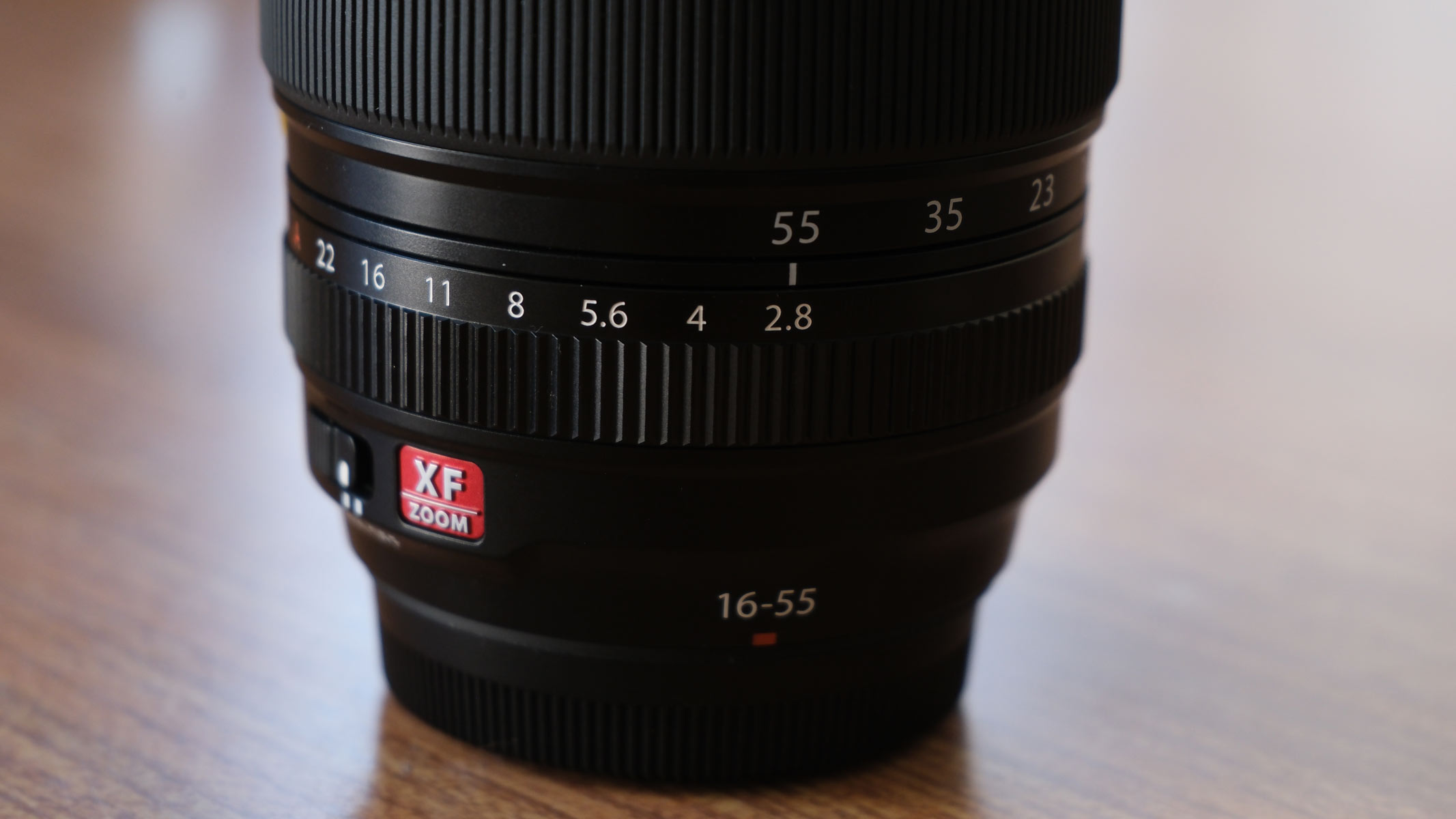 A Fujifilm XF 16-55mm f/2.8 LM WR II lens, showing the dials for focal length and aperture
