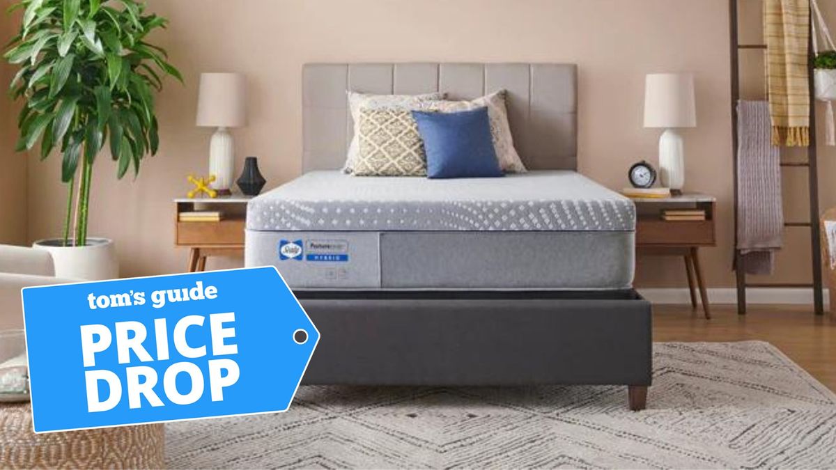 Sealy Posturepedic® Hybrid Lacey 13&quot; Firm Mattress in a well-lit bedroom with a deal badge 