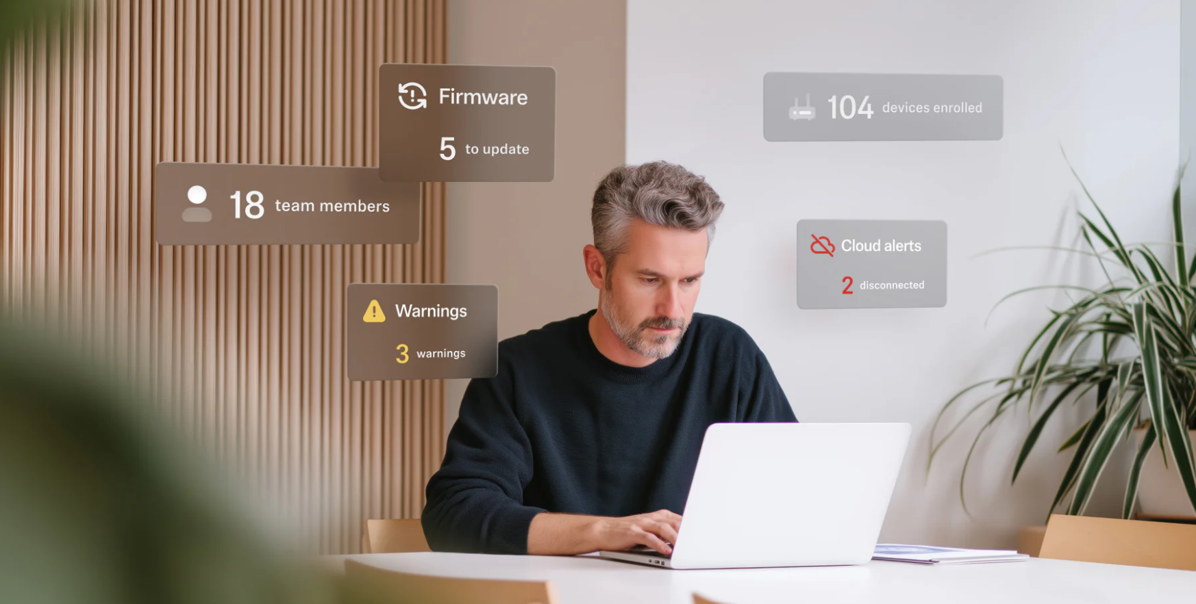 A man using a laptop with superimposed blocks showing security and updates.