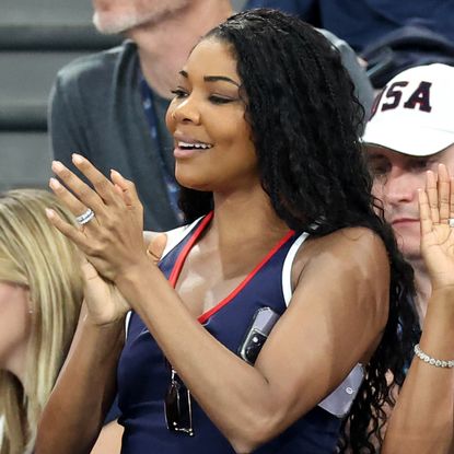 Gabrielle Union in Paris France watching the Olympics while wearing a navy tank dress