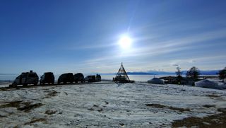 Tent and vehicles in the snow during Rat Race's Mongol 100 ultra