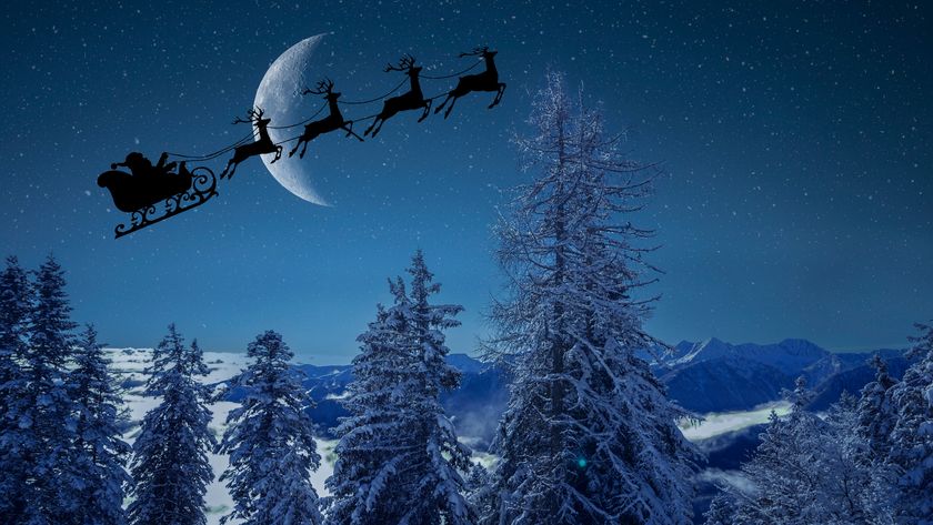 santa's sleigh being pulled by 4 reindeer against the moon in a dark sky above a snowy forest scene