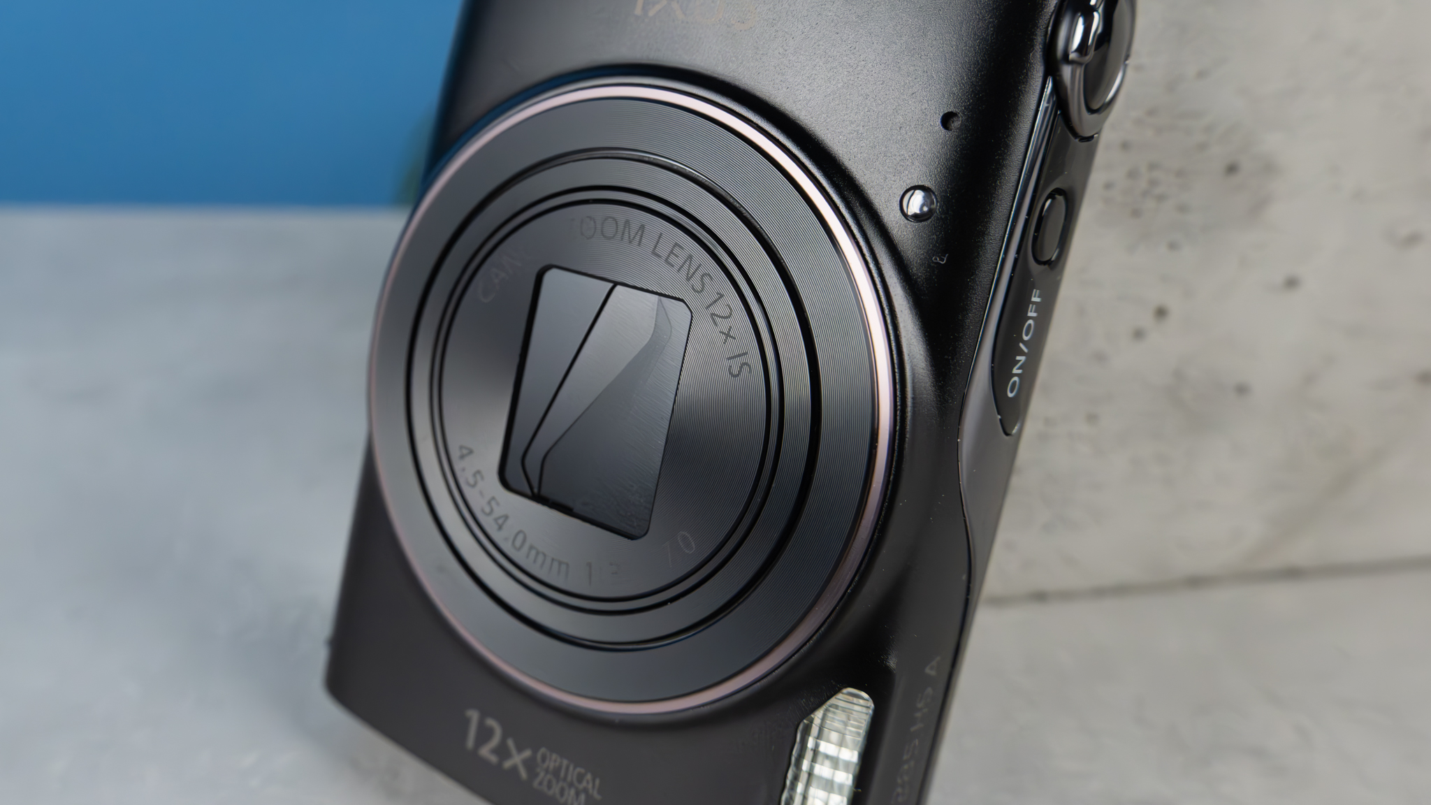 A black Canon PowerShot Elph 360 HS A or Canon PowerShot IXUS 285 HS A compact camera