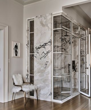 marble design shower, glass door, wooden floor