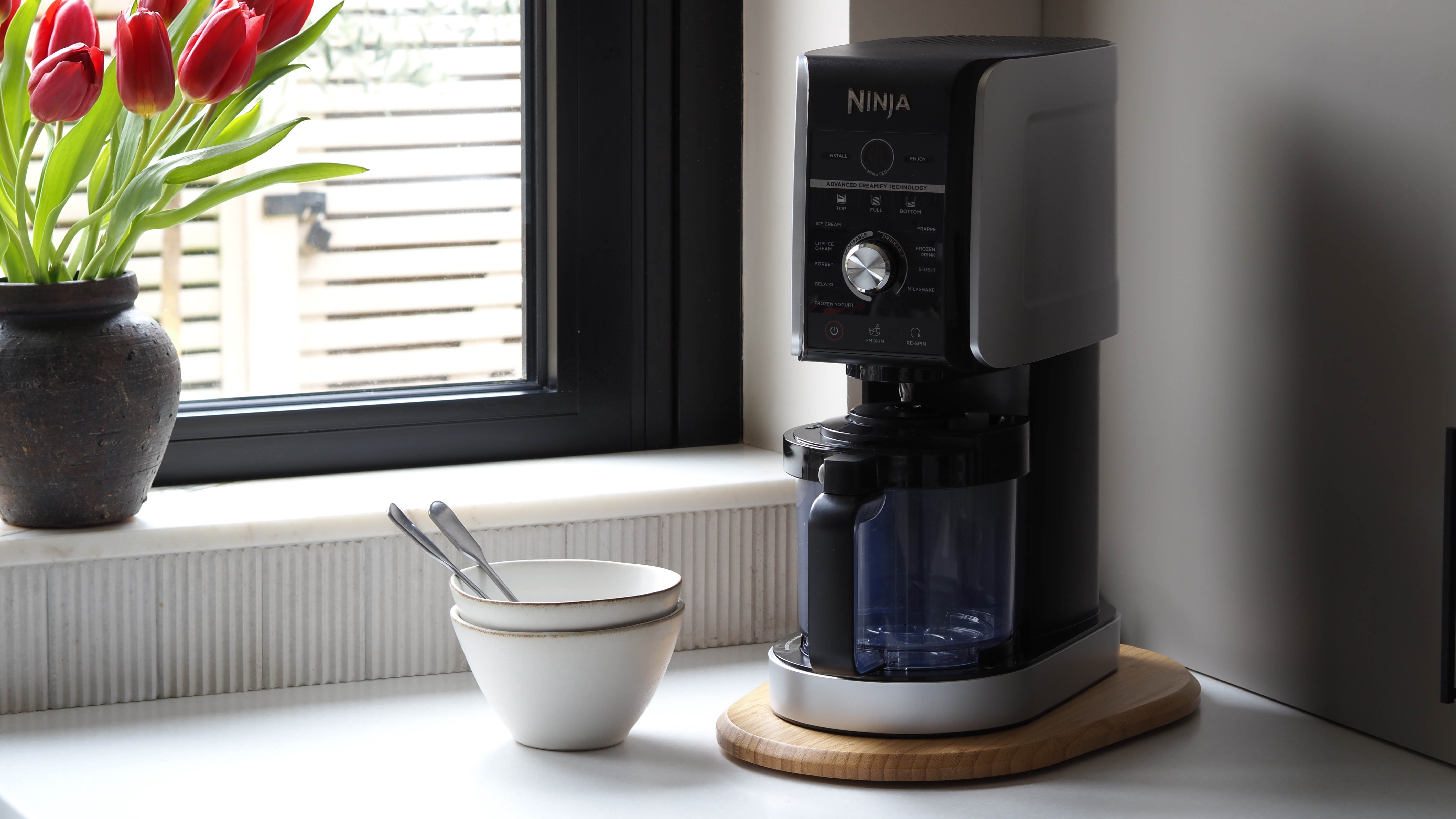 a timber sliding board under neat a kitchen appliance 