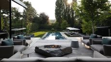 timber deck overlooking a pool at sundown