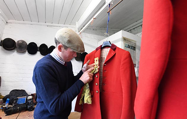 Attention to detail: Harry Horton, first whipper-in polishes the buttons on his hunt coat