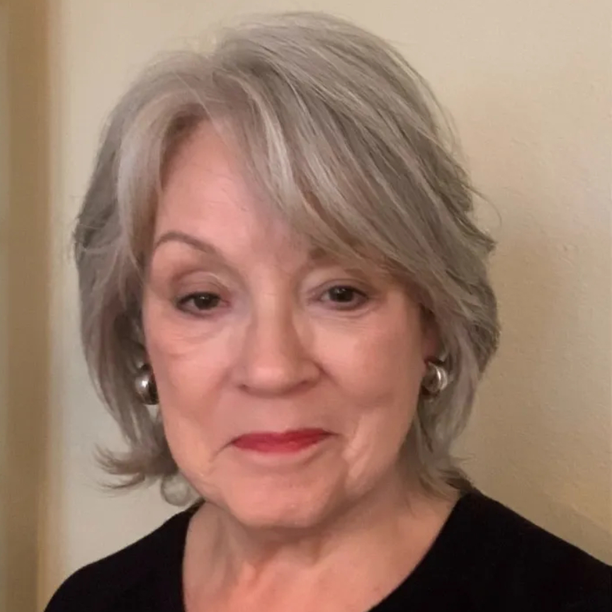 A woman with gray hair and a black shirt after Dr. Jart+ BB Tinted Moisturizer With Niacinamide and SPF 40.