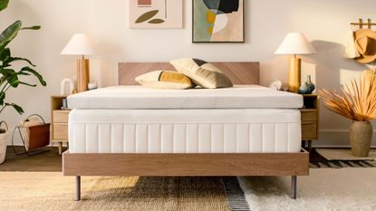 When to buy a mattress topper. Colorful bedroom with bed with tempur-pedic mattress topper, artwork on walls