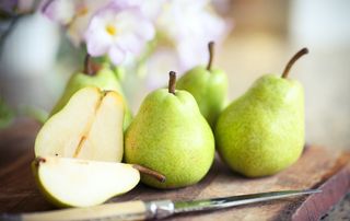 Five fresh pears one sliced