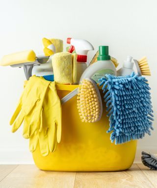 A yellow bucket filled with cleaning supplies