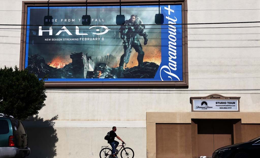 A cyclist passes by signage outside the Paramount lot in Los Angeles. 