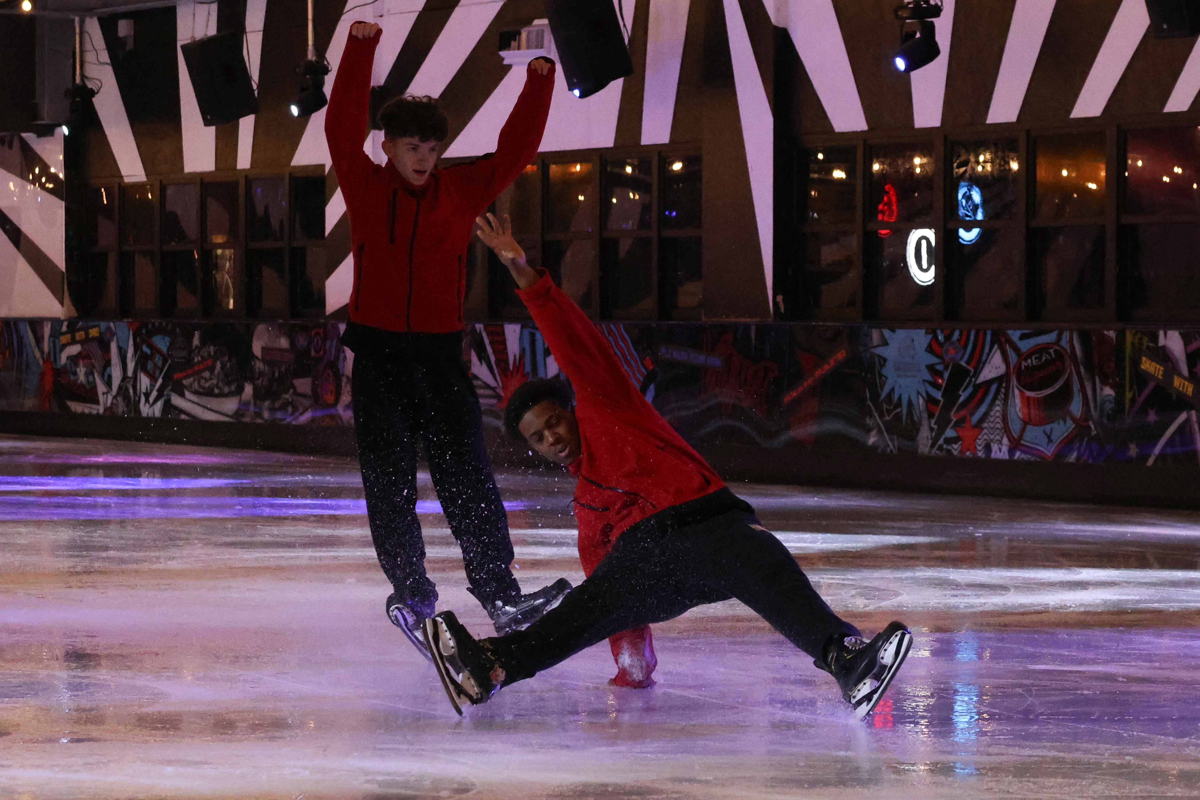 Two ice skaters performing a routine