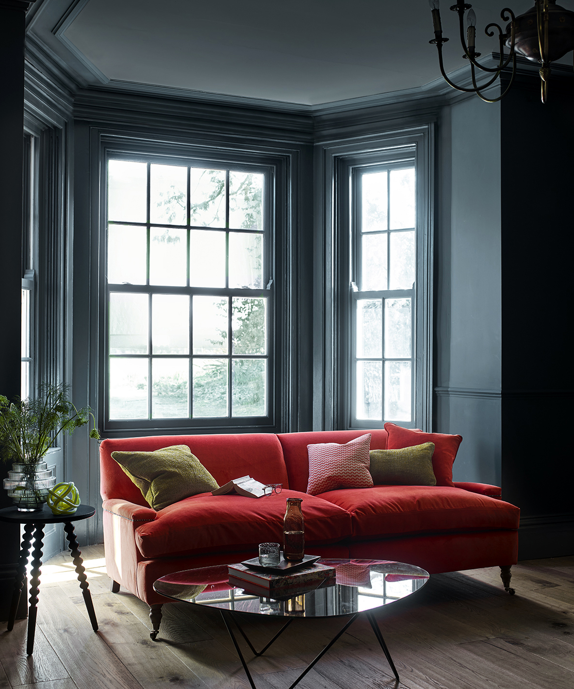 Red sofa in a dark painted living room