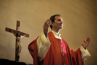 a catholic priest leading a service