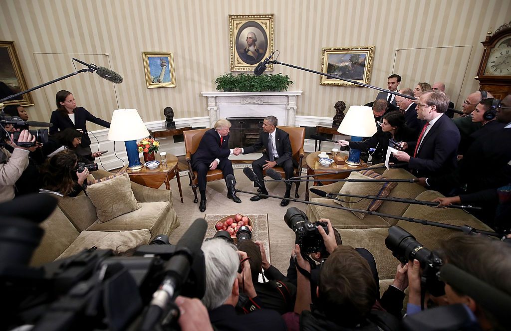 Staffers look on as President Obama and Trump meet.