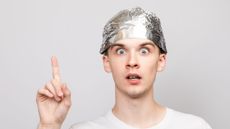 Man with tin foil hat on.