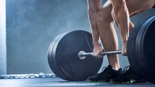 a photo of a man in the gym doing a deadlift