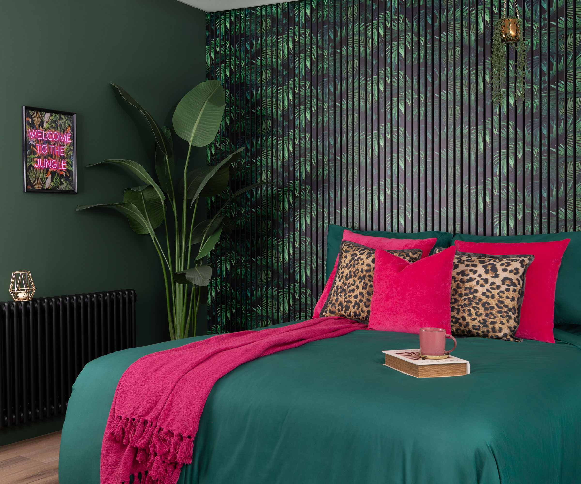 teal and pink bedroom with jungle patterned wall panelling