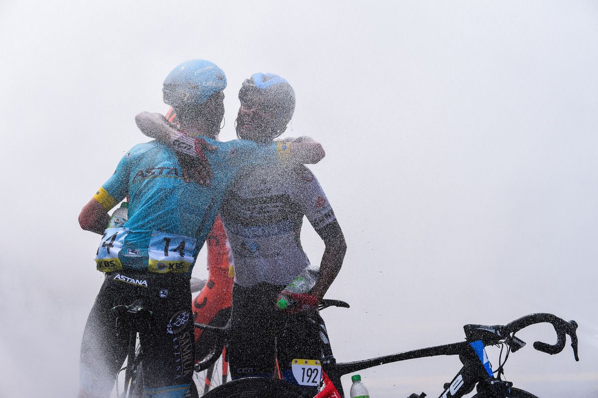 Riccardo Minali (Astana) and Mohd Harrif Saleh (TSG) hug after the stage