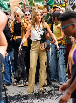 Jennifer Aniston getting oil thrown on her cute wide legs during The Morning Show taping.