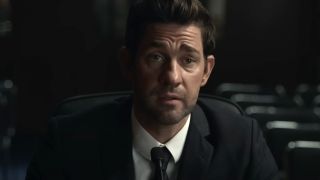 John Krasinski sits solemnly during testimony in Tom Clancy's Jack Ryan.