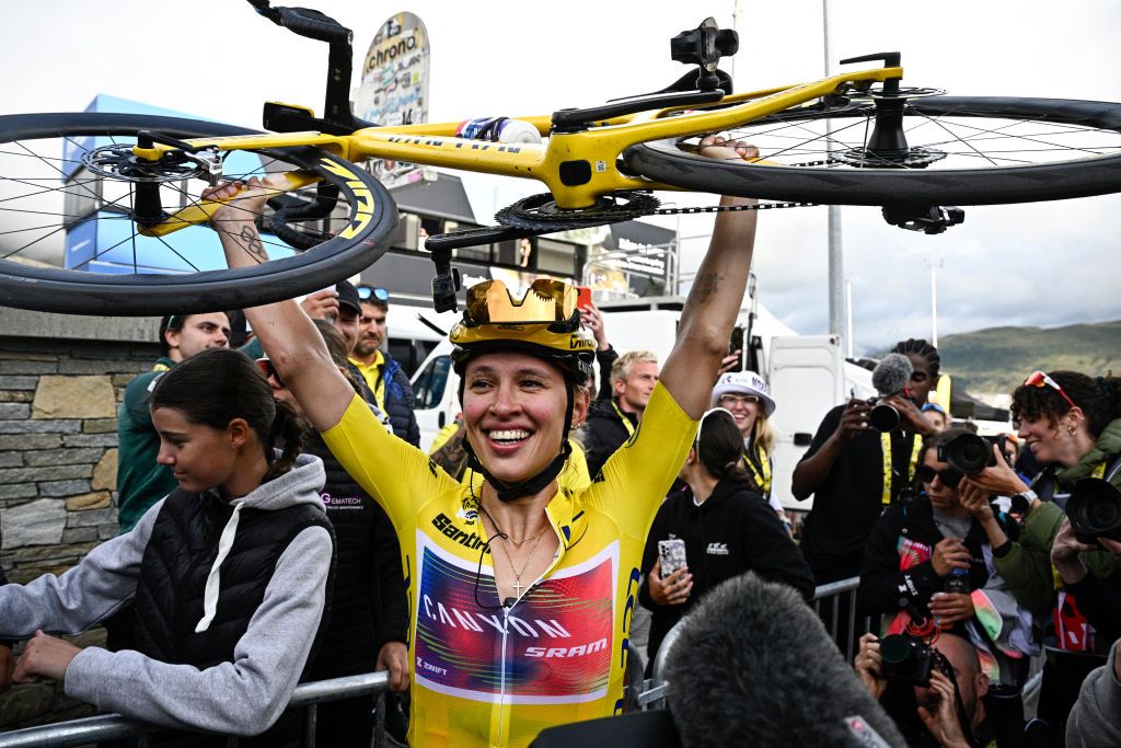 Canyon//SRAM Racing team's Polish rider Katarzyna Niewiadoma celebrates after crossing the finish line and winning the third edition of the Women's Tour de France cycling race, after the 8th and last stage of the Tour de France, a 149.9 km between Le Grand Bornand and the Alpe d'Huez, in south-eastern France, on August 18, 2024. (Photo by JULIEN DE ROSA / AFP)