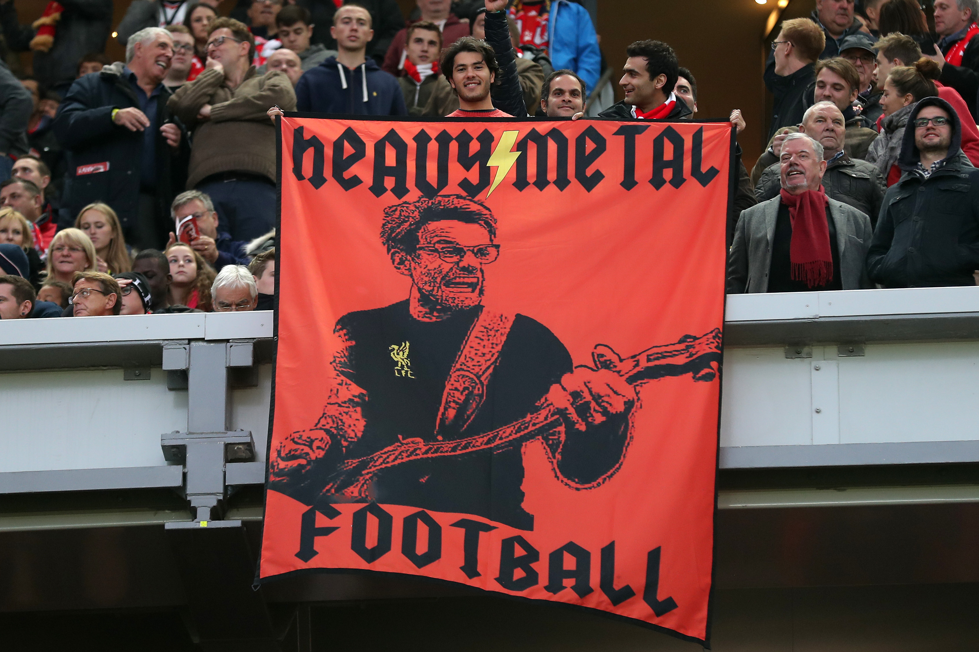 Liverpool fans with a banner featuring an image of manager Jurgen Klopp and the words 