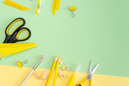 yellow school supplies on a green background