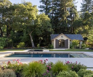 Modern, elegant backyard pool with ivory porcelain patio tiles