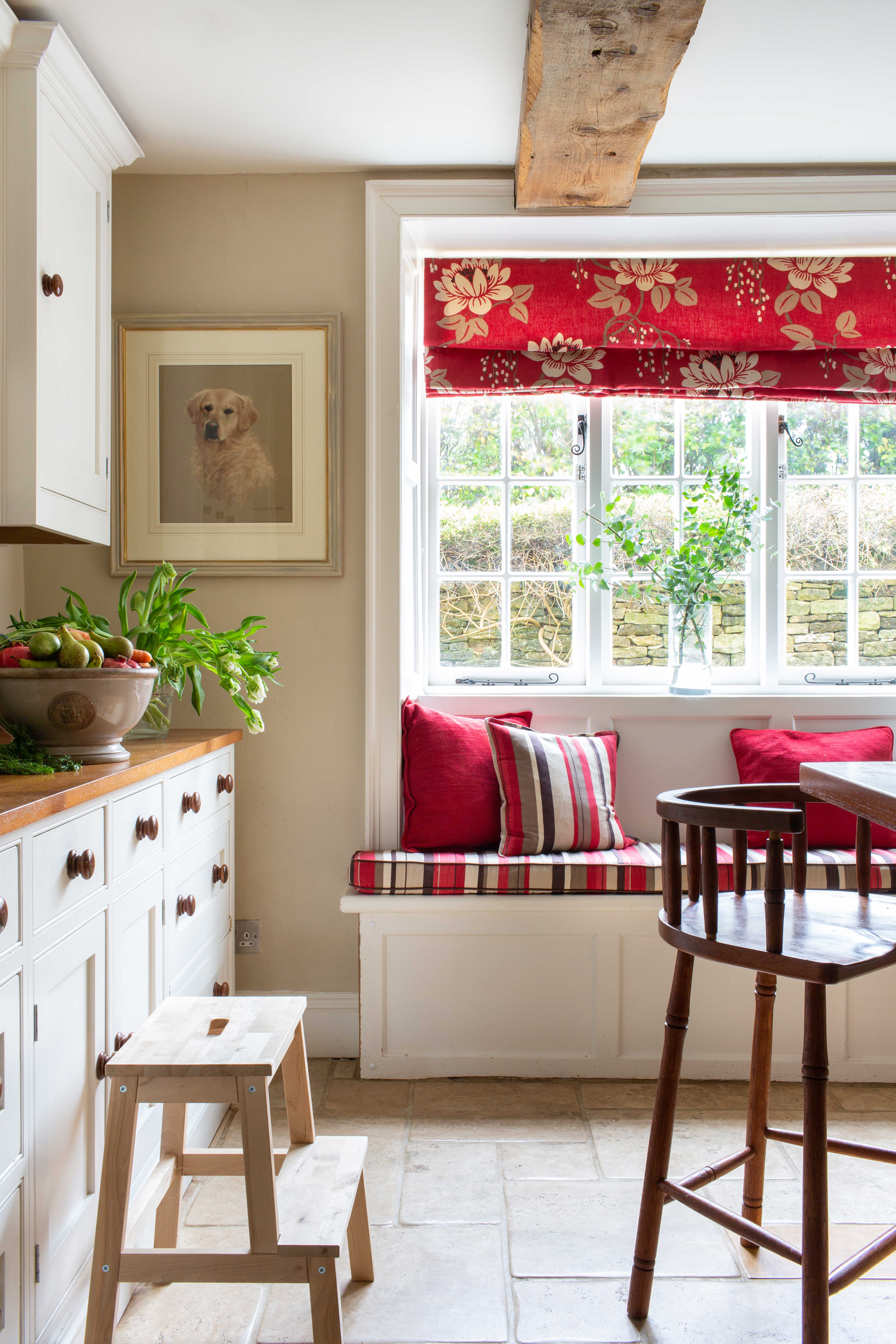 kitchen-with-white-cabinets-red-blinds-and-large-central-island