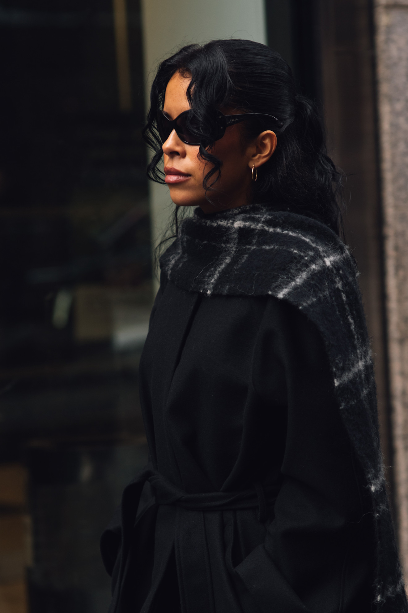 A woman wears oversize sunglasses during fashion week