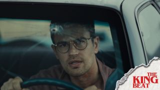 Theo James driving a car with a bullet in the windshield in The Monkey The King Beat